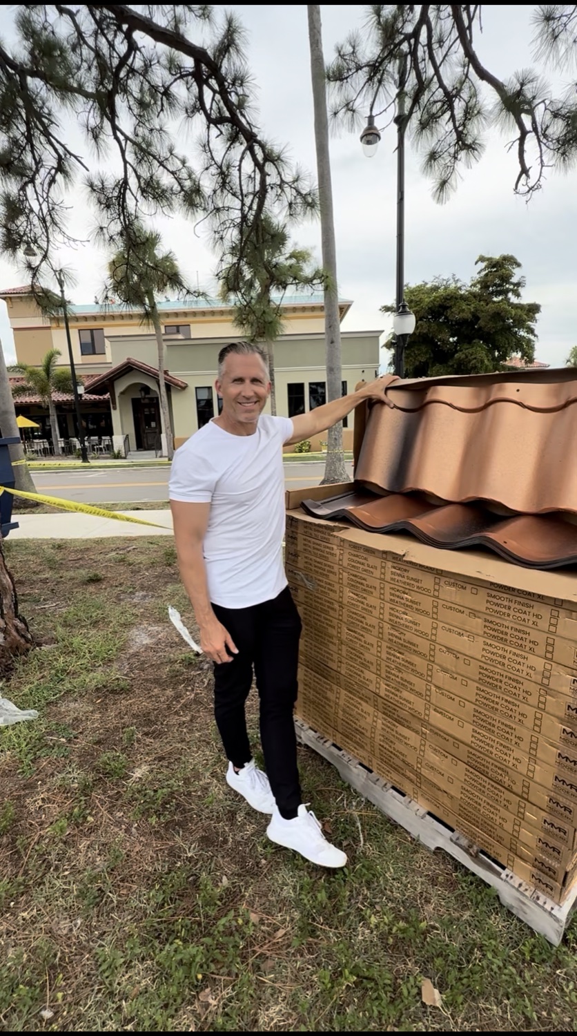 Bryan with a pallet of clay roof tiles — learning the trade