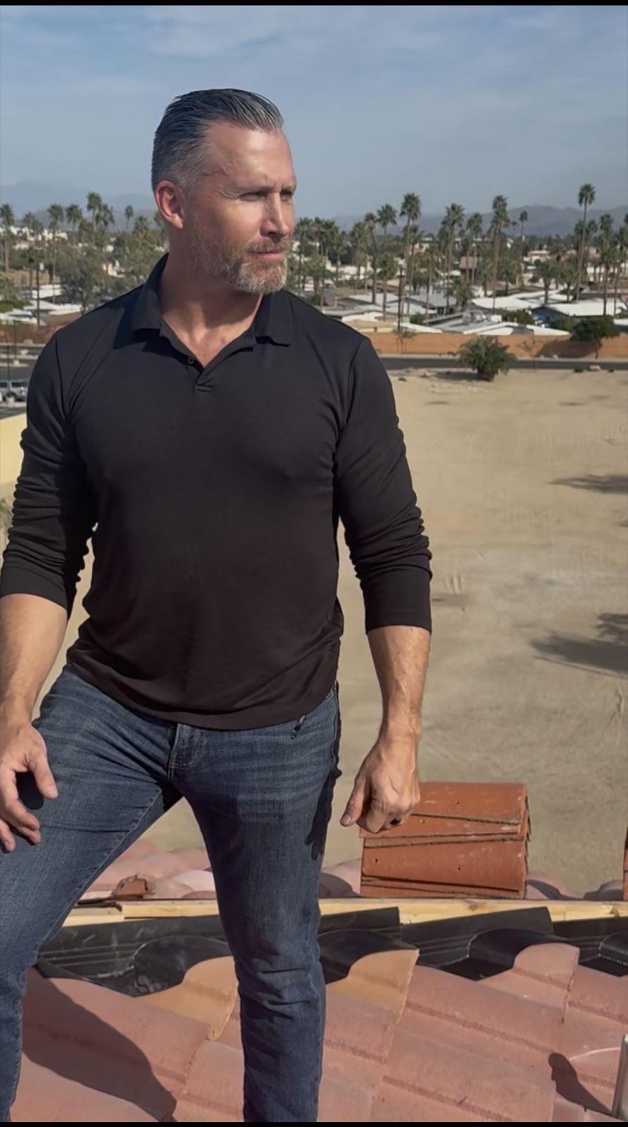 Bryan Stephens on a Scottsdale tile roof, holding a clay tile